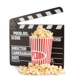 Tasty popcorn and movie clapper isolated on white