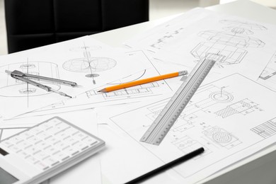 Photo of Different engineering drawings and tools on table in office