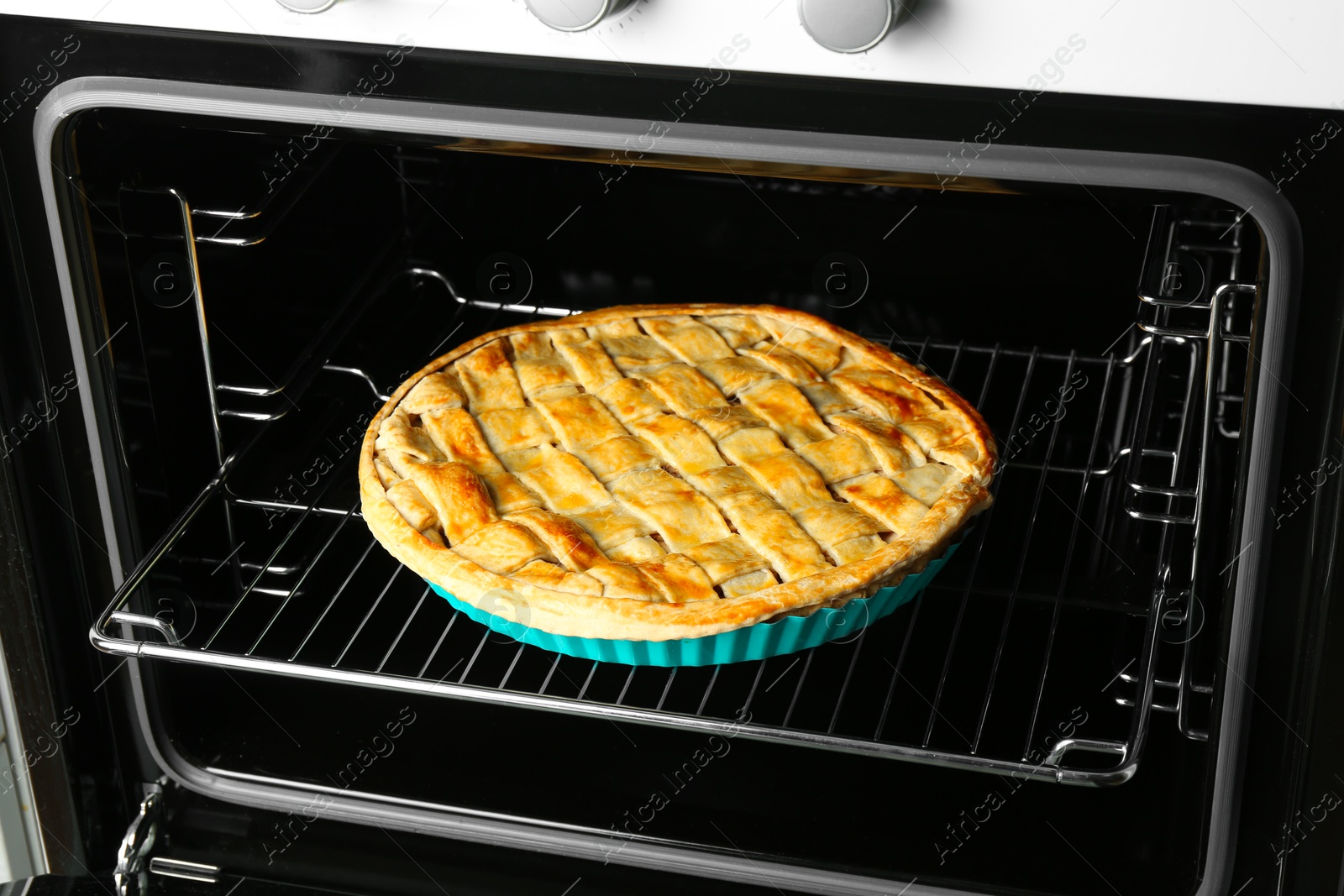 Photo of Baking dish with homemade apple pie in oven