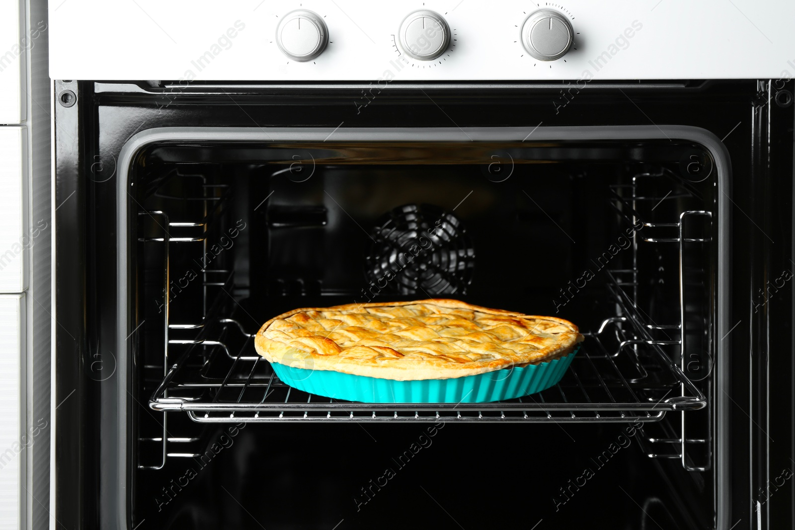 Photo of Baking dish with homemade apple pie in oven