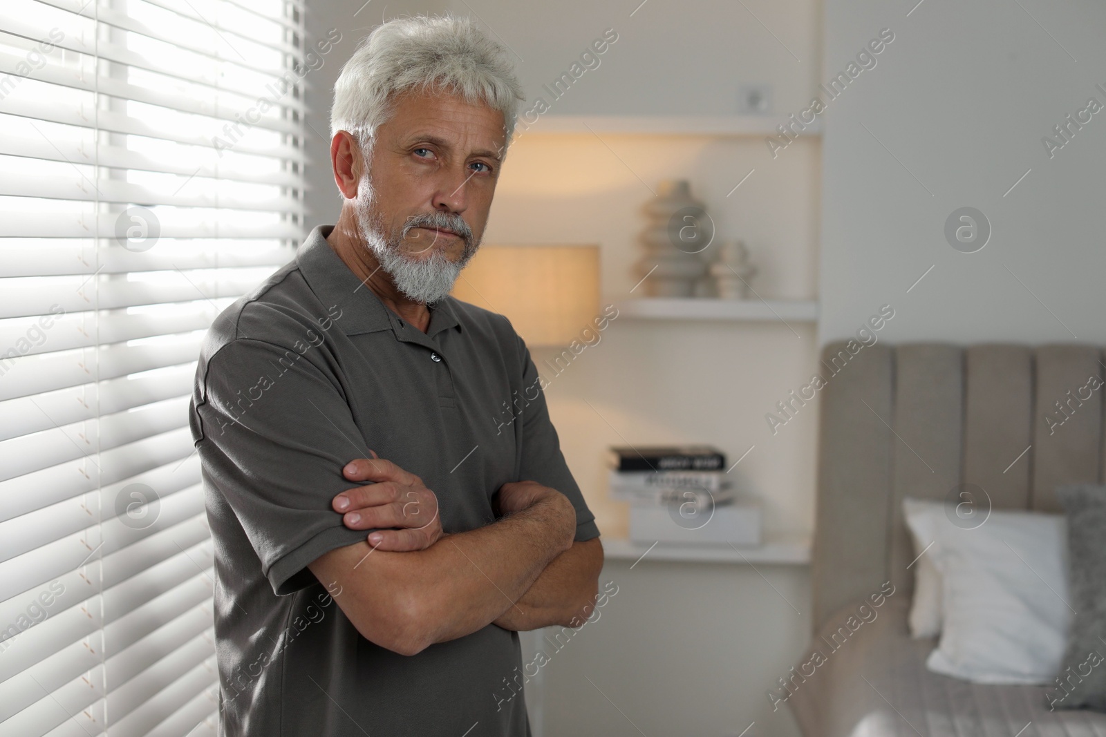 Photo of Sad senior man feeling lonely at home