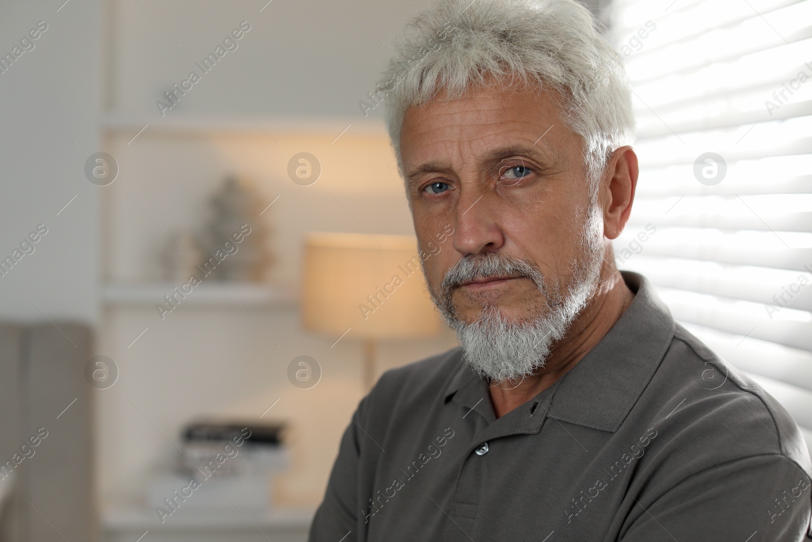 Photo of Sad senior man feeling lonely at home