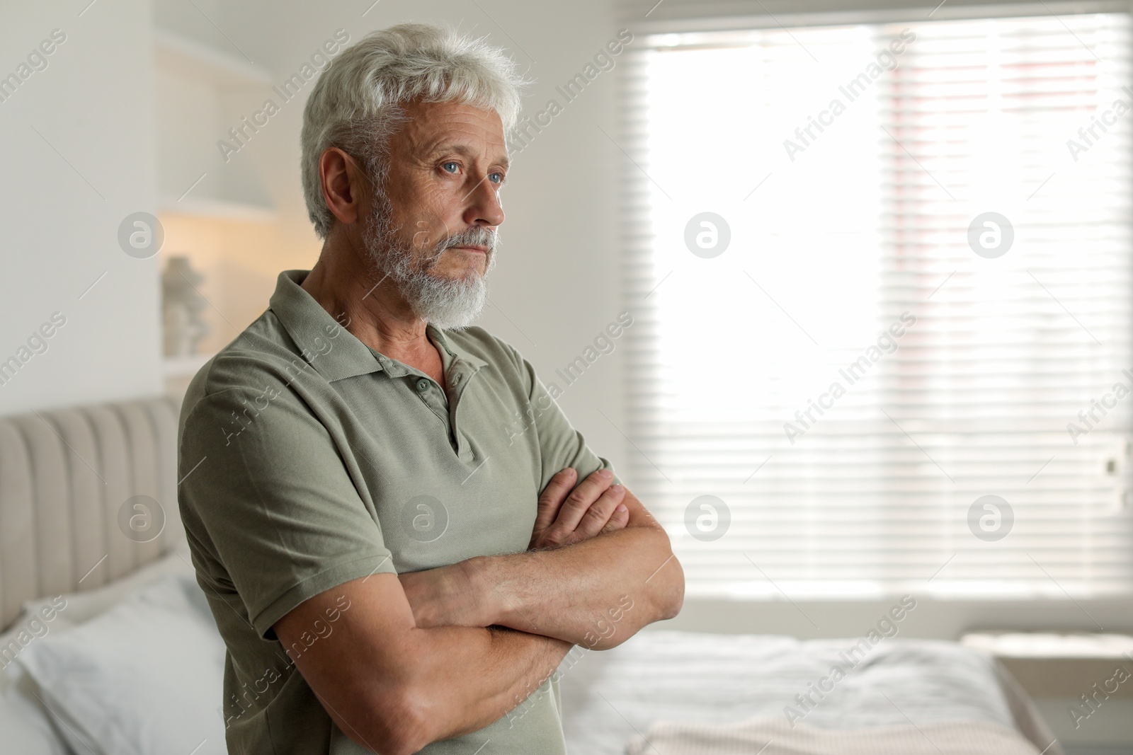 Photo of Portrait of lonely senior man at home. Space for text