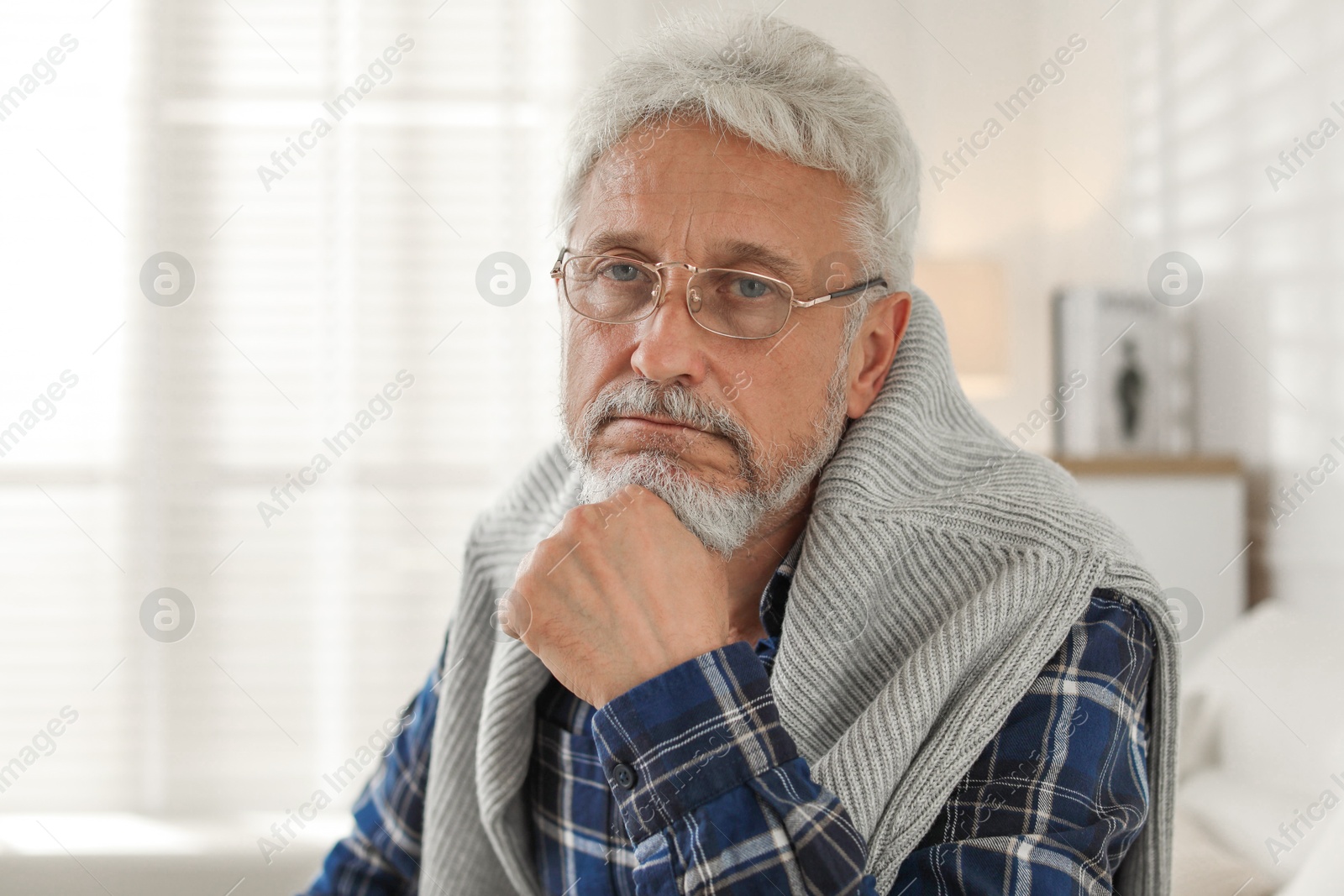 Photo of Sad senior man feeling lonely at home