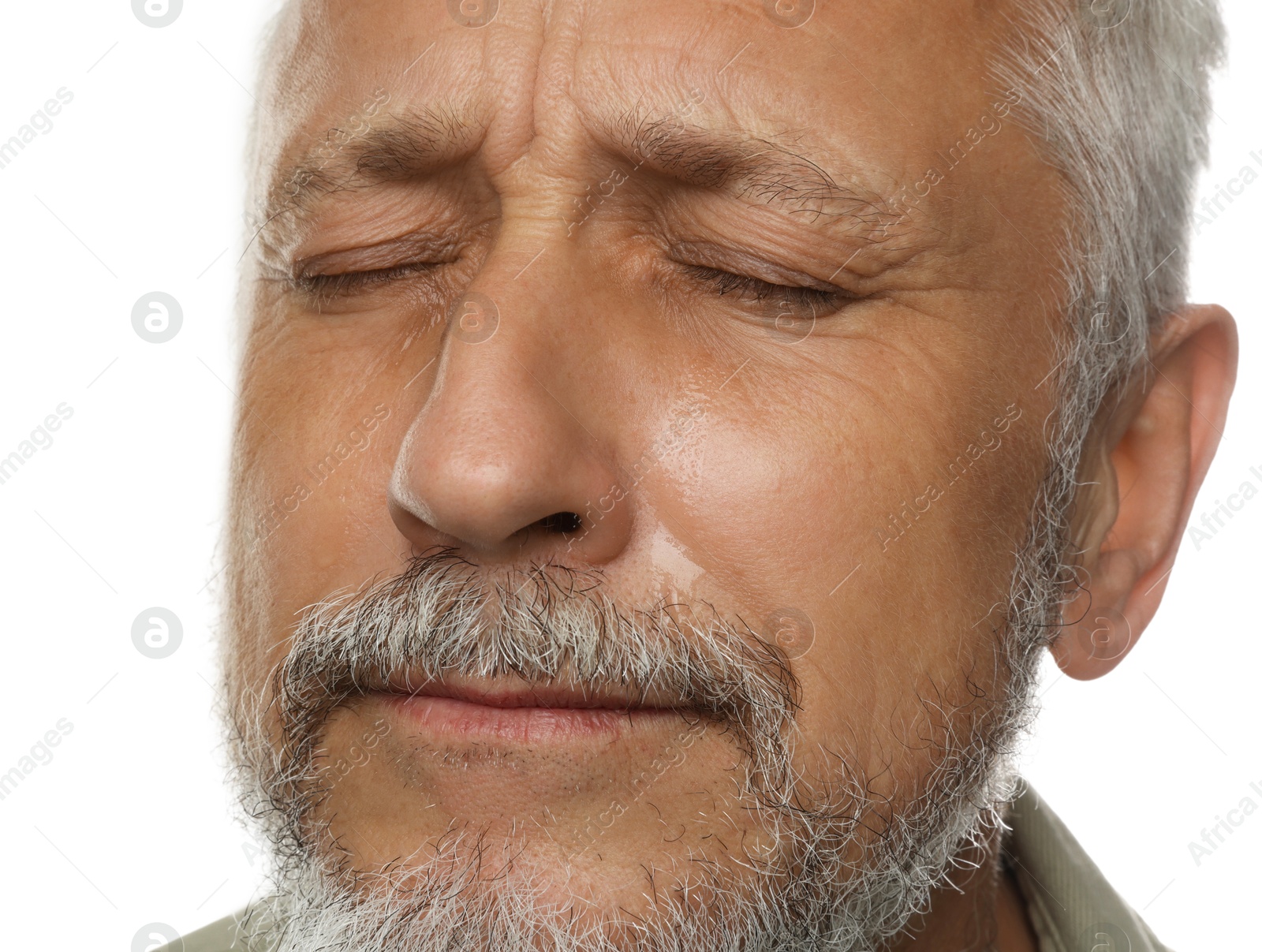 Photo of Sad senior man crying on white background, closeup