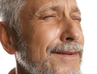 Photo of Sad senior man crying on white background, closeup