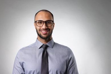 Photo of Portrait of businessman in glasses on light gray background, space for text