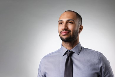 Photo of Portrait of businessman on light gray background, space for text