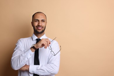 Photo of Portrait of businessman with glasses on beige background, space for text