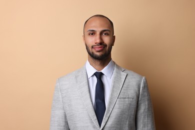 Photo of Portrait of businessman in jacket on beige background