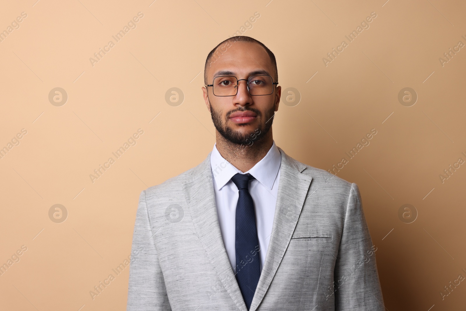 Photo of Portrait of businessman in glasses on beige background