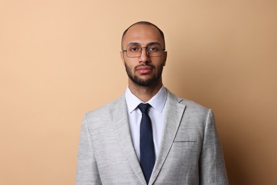 Photo of Portrait of businessman in glasses on beige background