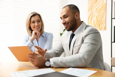 Photo of Coworkers with tablet working together in office