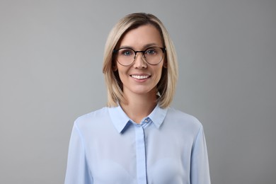 Photo of Portrait of businesswoman in glasses on gray background