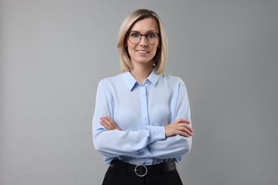 Photo of Portrait of businesswoman in glasses on gray background