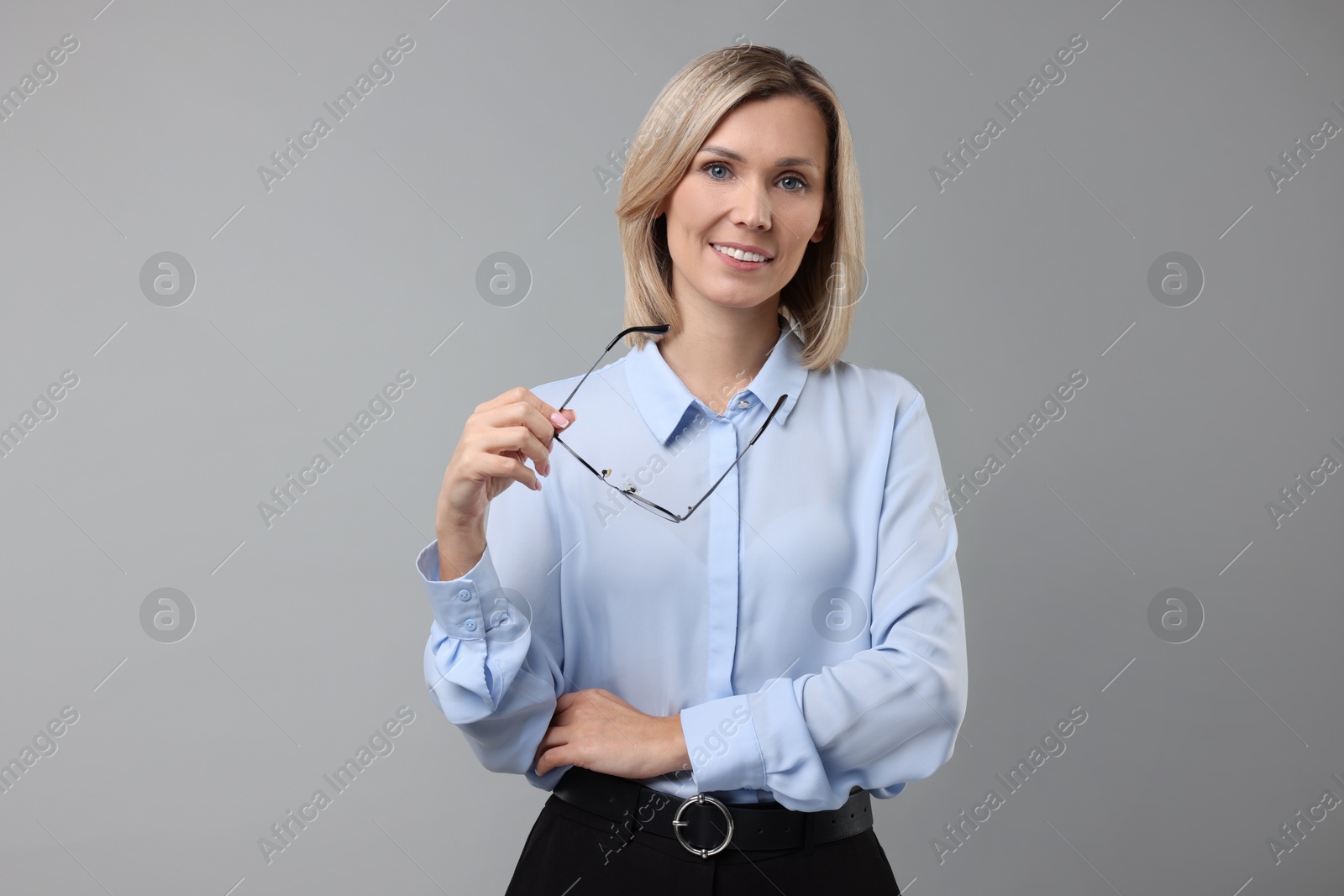 Photo of Portrait of businesswoman with glasses on gray background