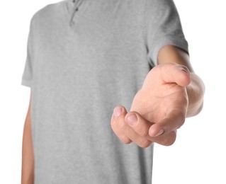 Photo of Offering help. Man reaching his hand on white background, closeup