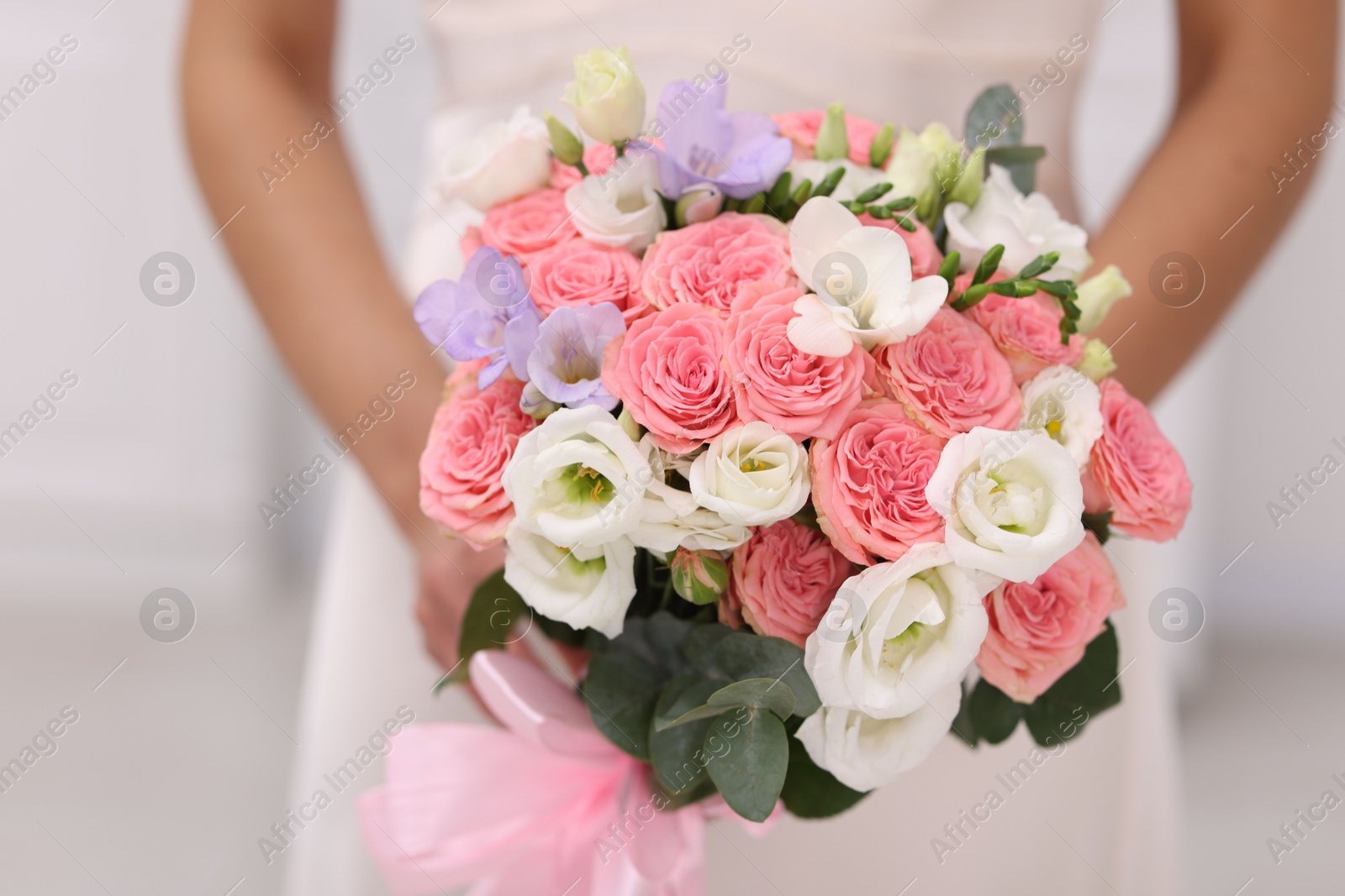 Photo of Bride with beautiful wedding bouquet on light background, closeup