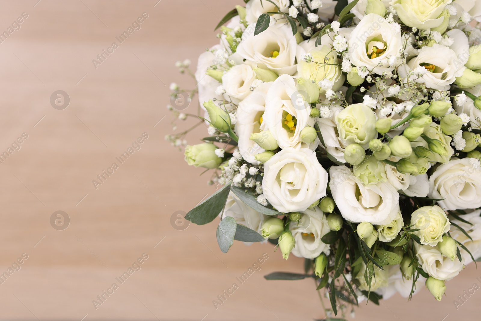 Photo of Beautiful wedding bouquet on light background, top view. Space for text