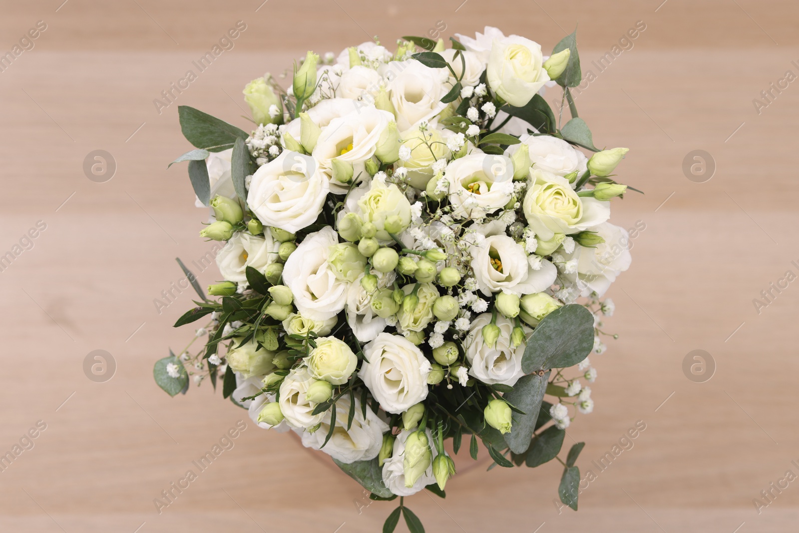 Photo of Beautiful wedding bouquet on light background, top view