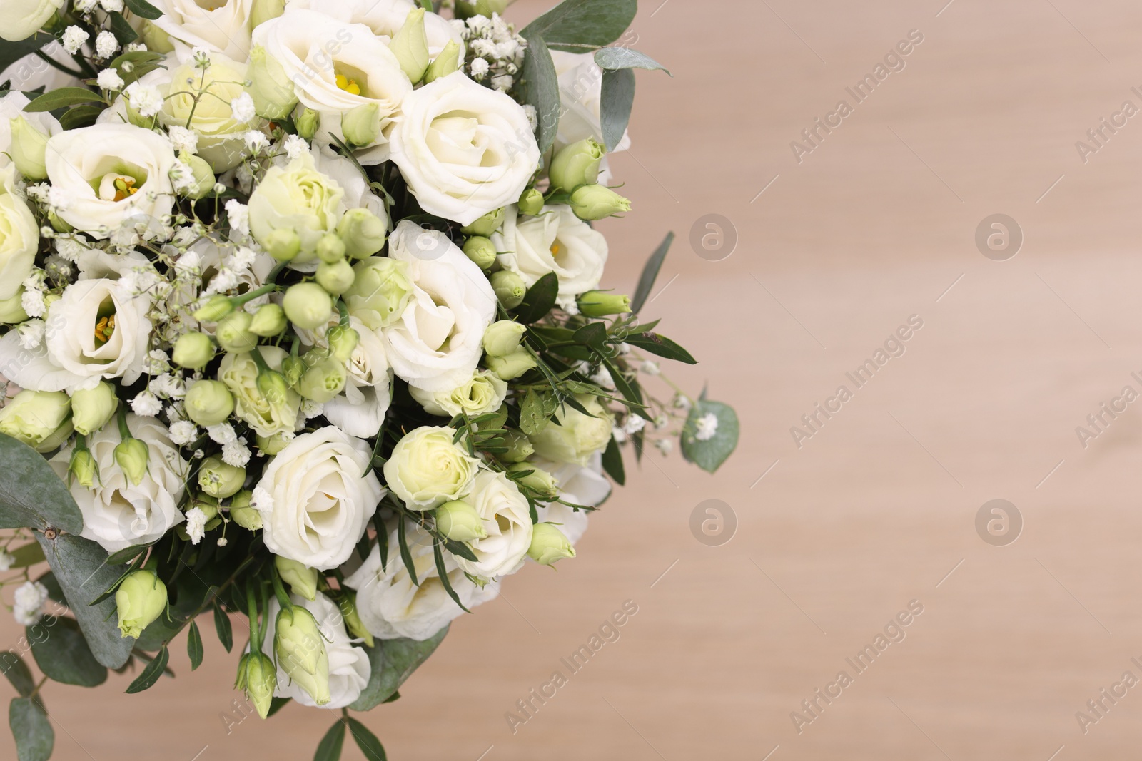 Photo of Beautiful wedding bouquet on light background, top view. Space for text