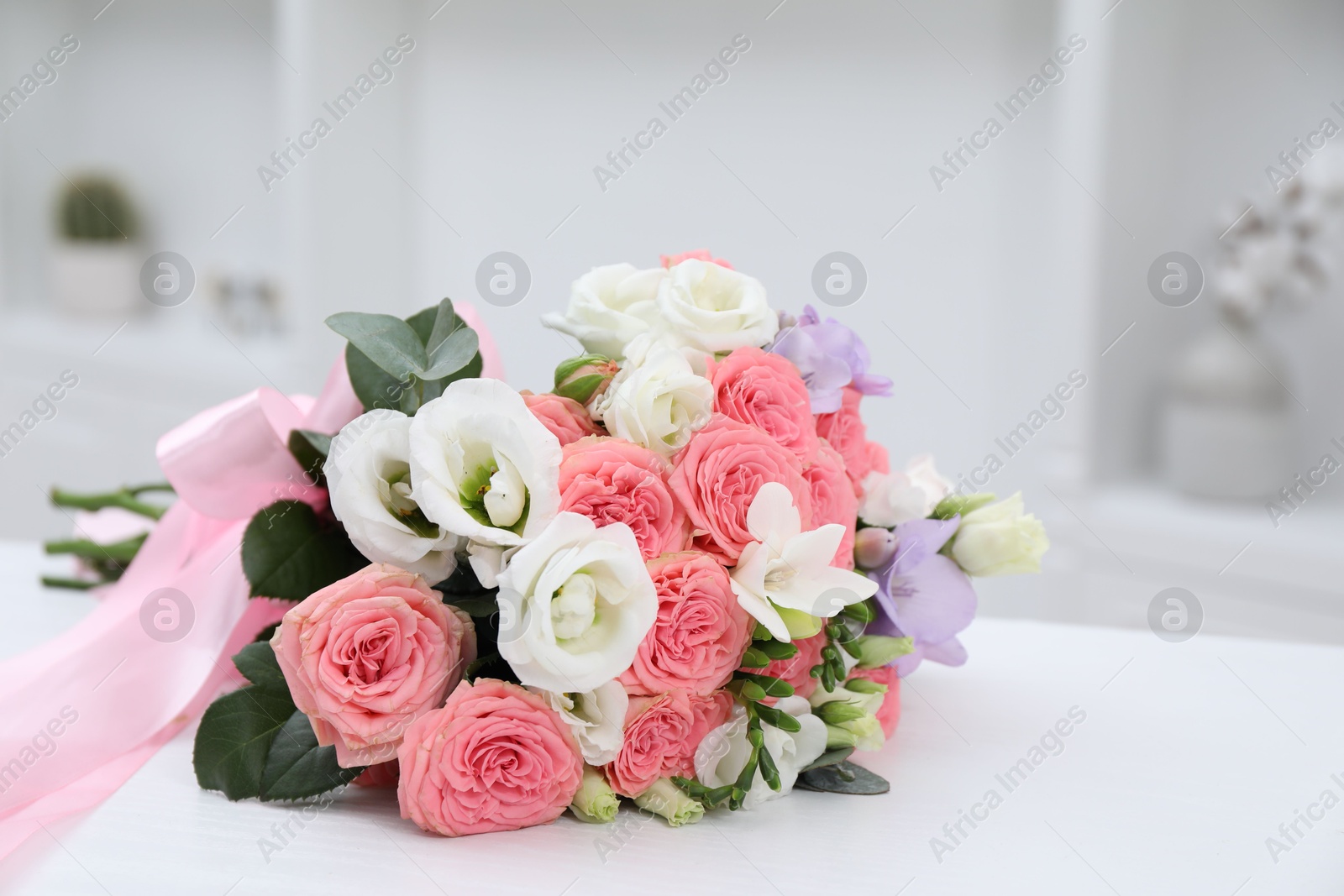 Photo of Beautiful wedding bouquet on white table indoors