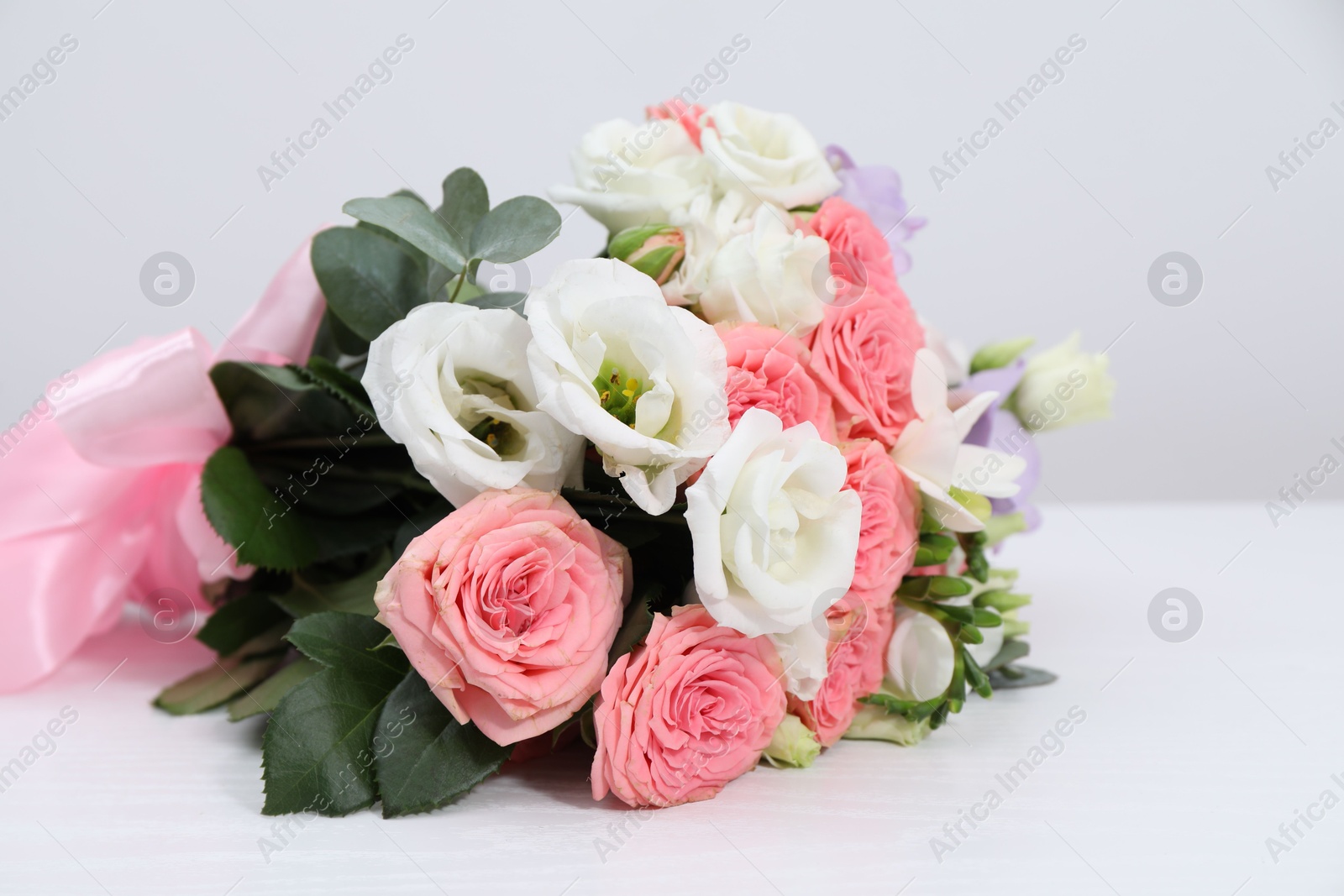 Photo of Beautiful wedding bouquet on white table, closeup