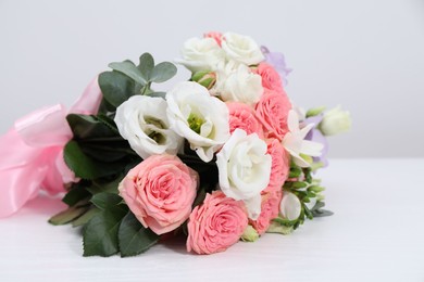 Photo of Beautiful wedding bouquet on white table, closeup