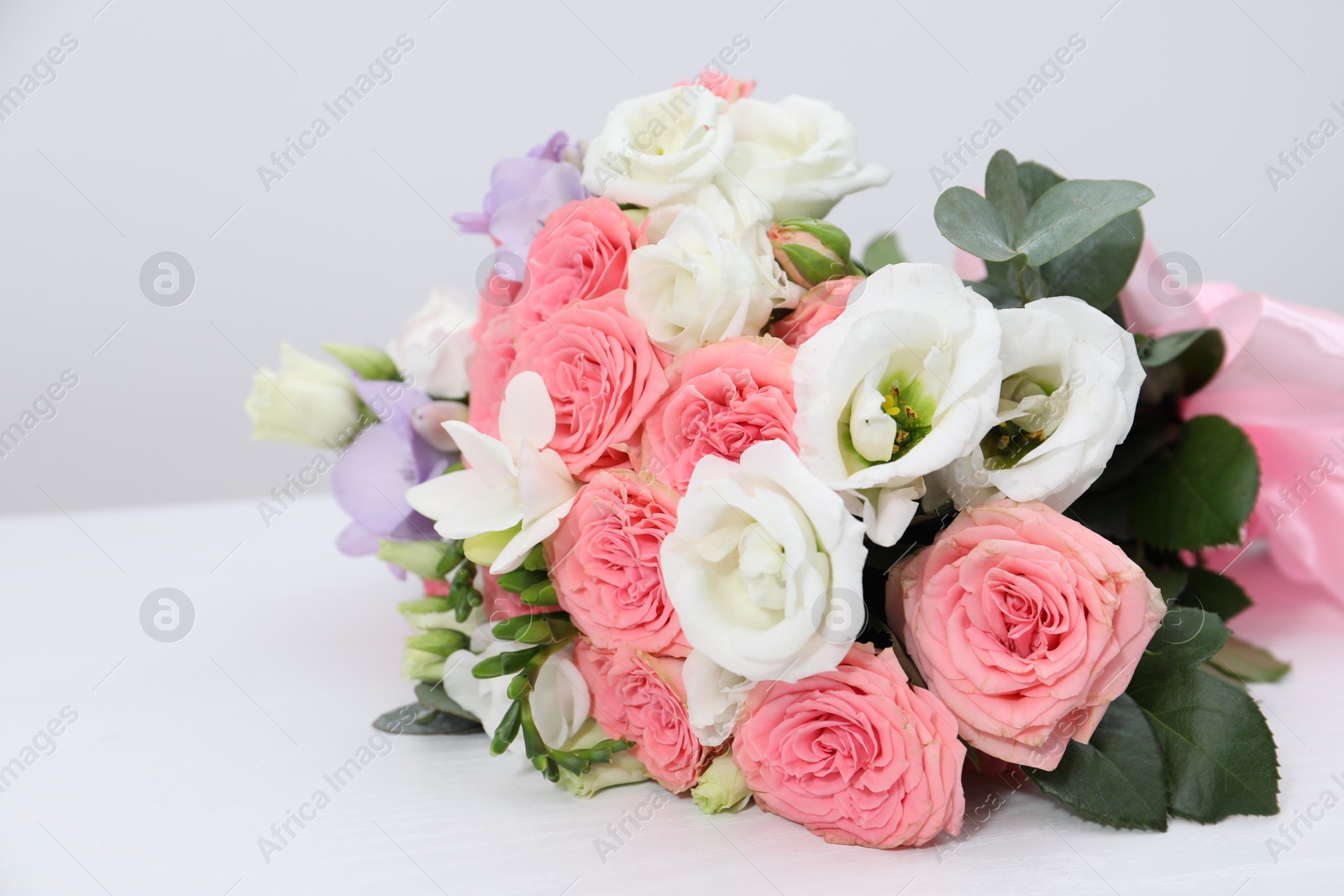 Photo of Beautiful wedding bouquet on white table, closeup