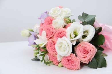 Photo of Beautiful wedding bouquet on white table, closeup