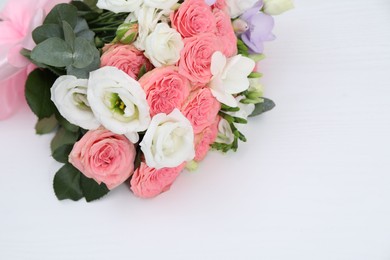 Photo of Beautiful wedding bouquet on white table, above view. Space for text