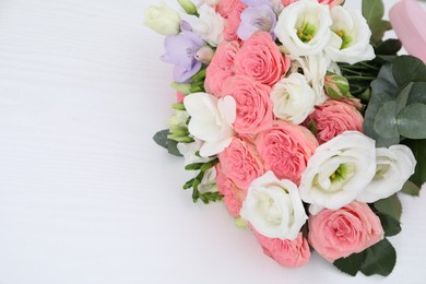 Photo of Beautiful wedding bouquet on white table, above view. Space for text