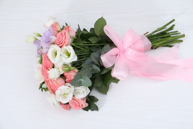 Photo of Beautiful wedding bouquet on white table, top view