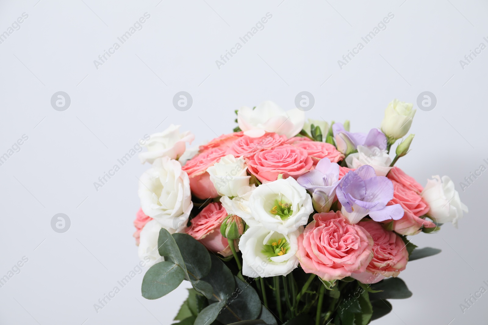 Photo of Beautiful wedding bouquet on light background, closeup. Space for text