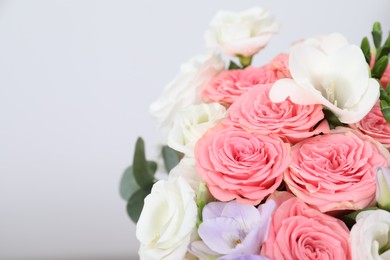 Photo of Beautiful wedding bouquet on light background, closeup. Space for text