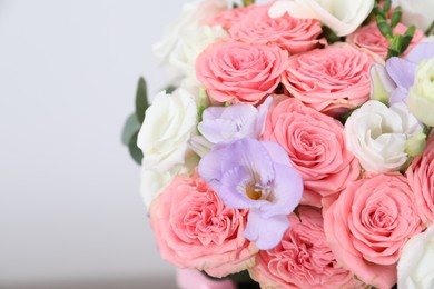 Photo of Beautiful wedding bouquet on light background, closeup. Space for text