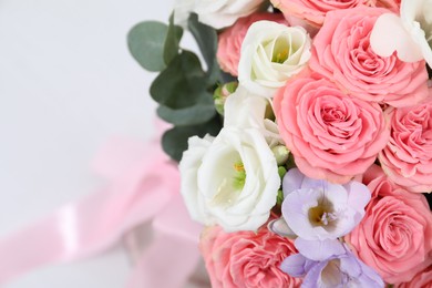 Photo of Beautiful wedding bouquet on light background, closeup. Space for text