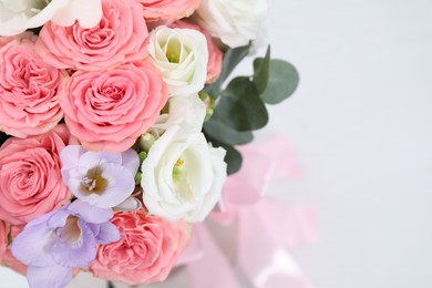 Photo of Beautiful wedding bouquet on light background, closeup. Space for text