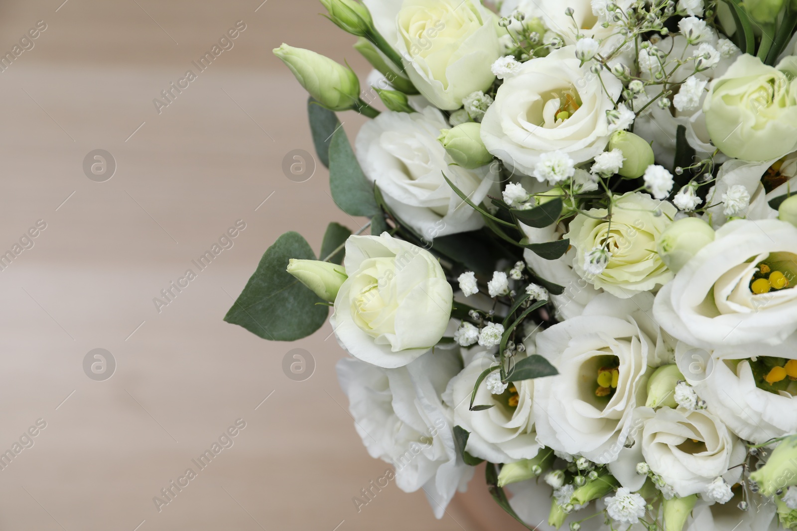 Photo of Beautiful wedding bouquet on light background, closeup. Space for text