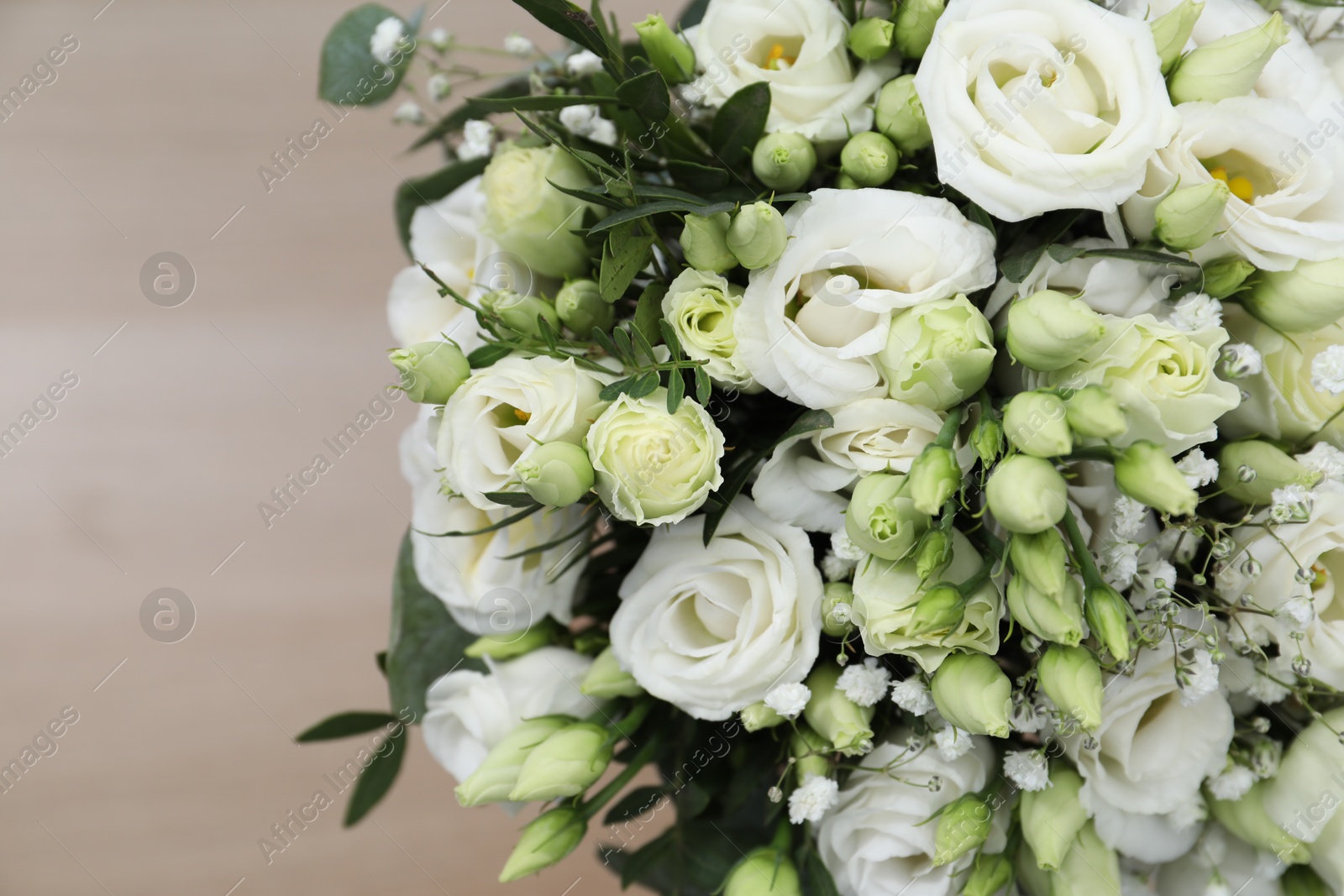 Photo of Beautiful wedding bouquet on light background, closeup. Space for text