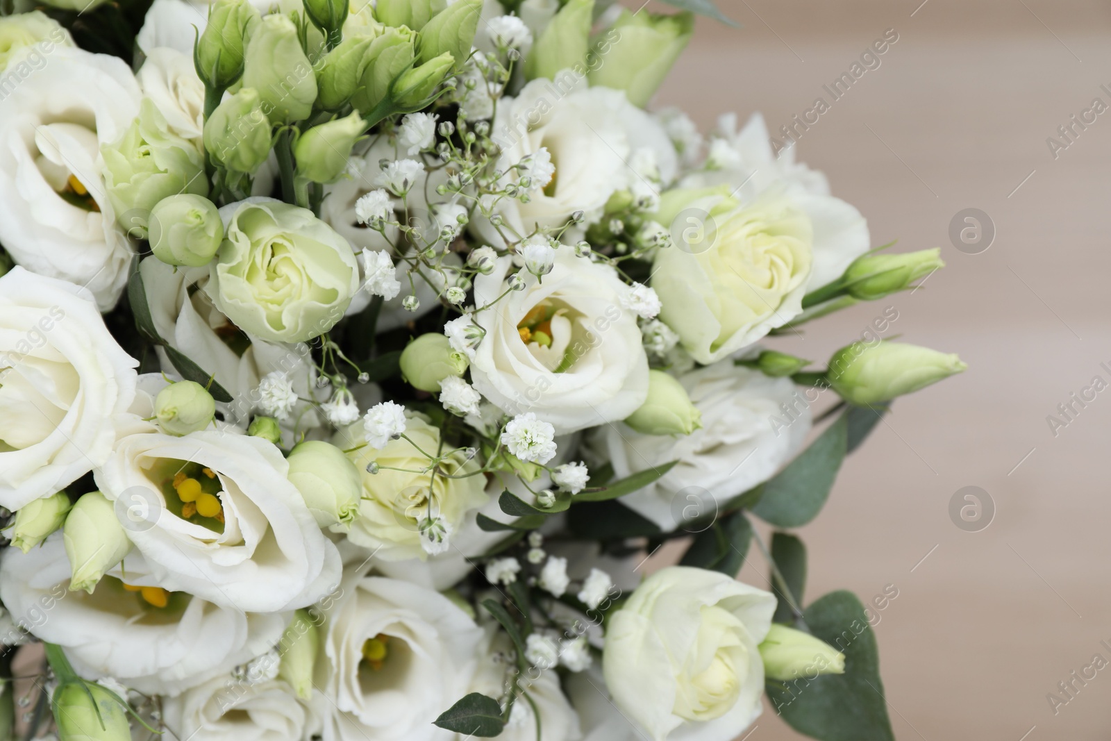 Photo of Beautiful wedding bouquet on light background, closeup.