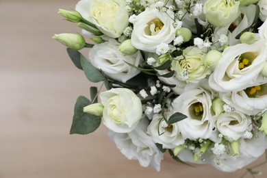 Photo of Beautiful wedding bouquet on light background, closeup. Space for text