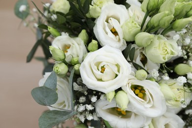 Photo of Beautiful wedding bouquet on light background, closeup.