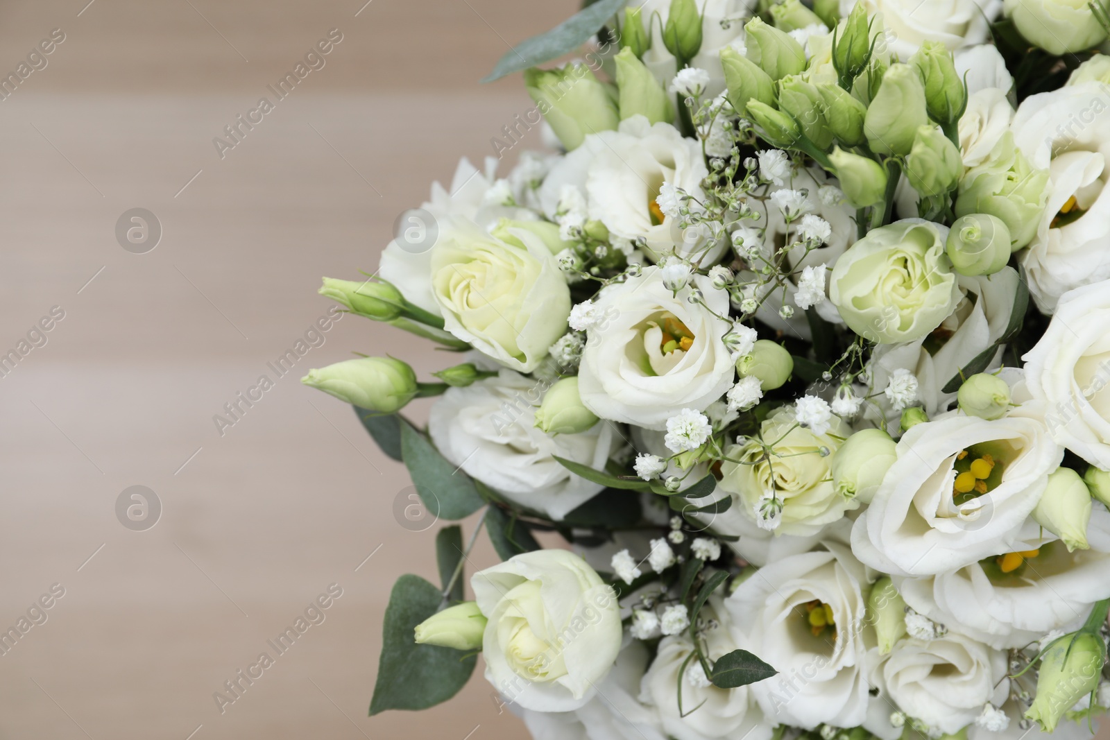 Photo of Beautiful wedding bouquet on light background, closeup. Space for text