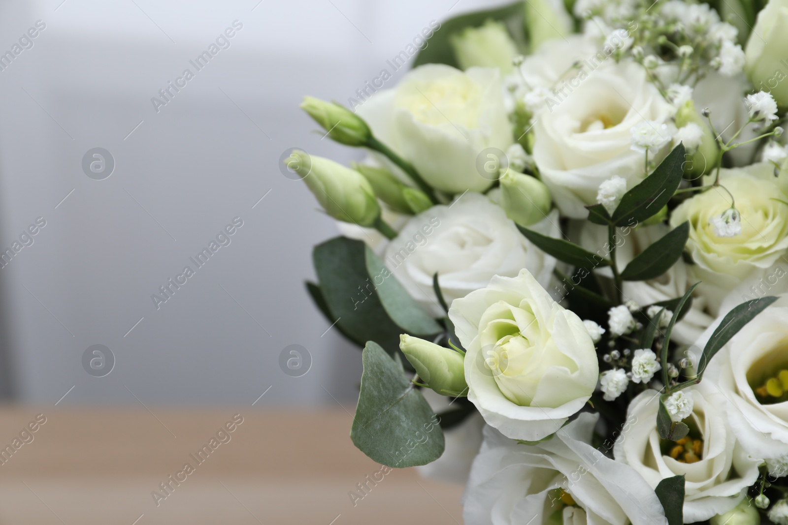 Photo of Beautiful wedding bouquet on light background, closeup. Space for text