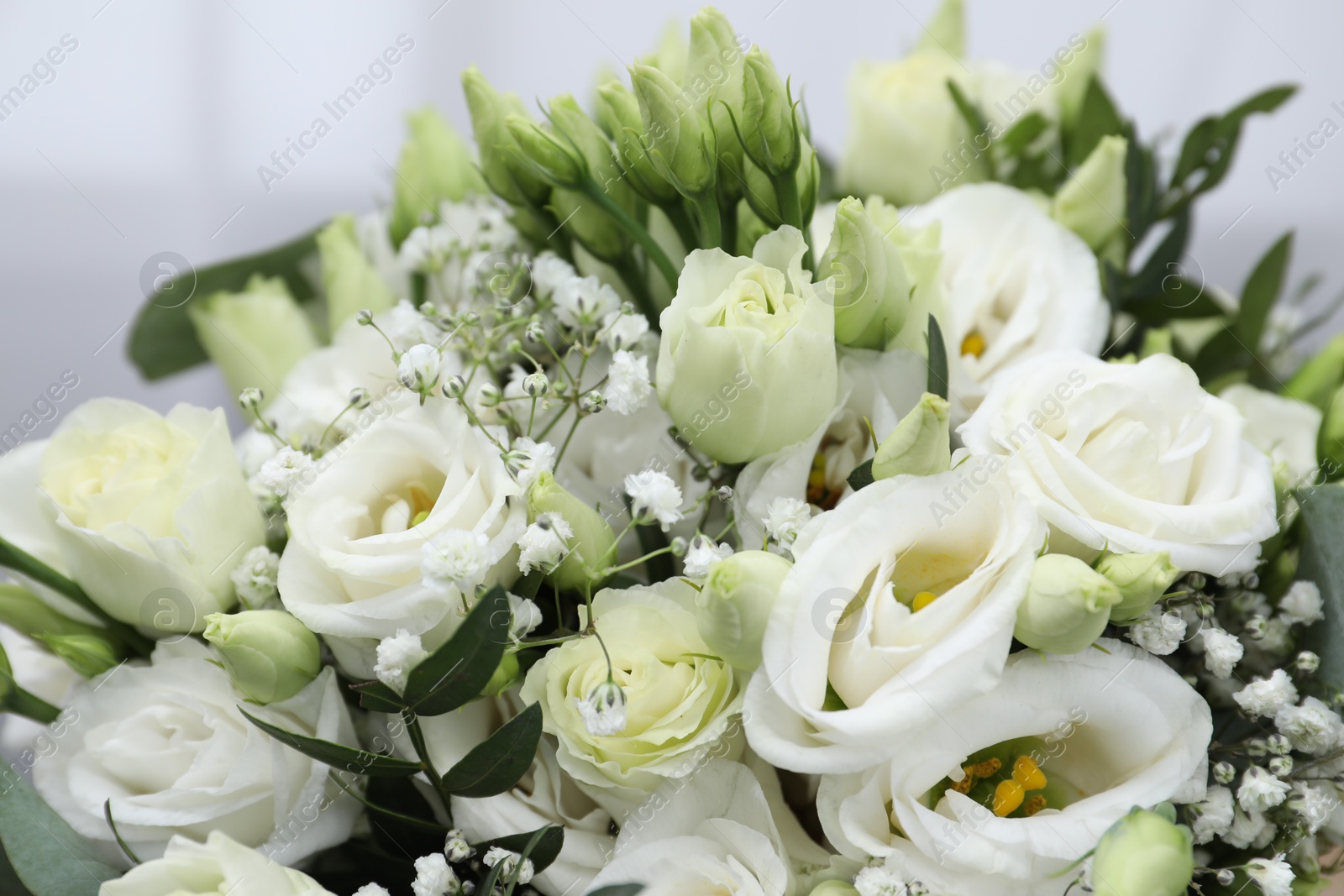 Photo of Beautiful wedding bouquet on light background, closeup.