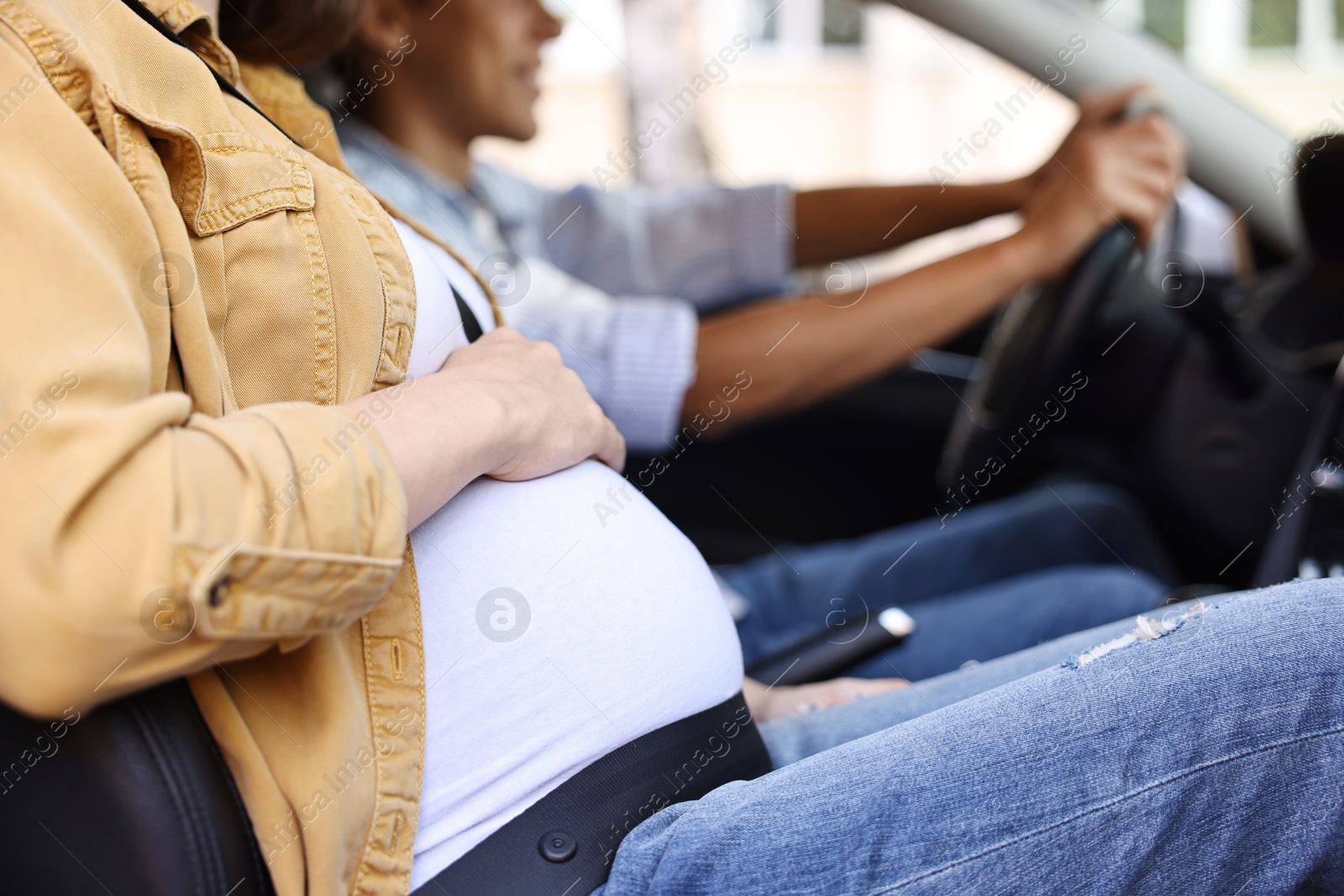 Photo of Pregnant woman travelling with her husband by car, closeup