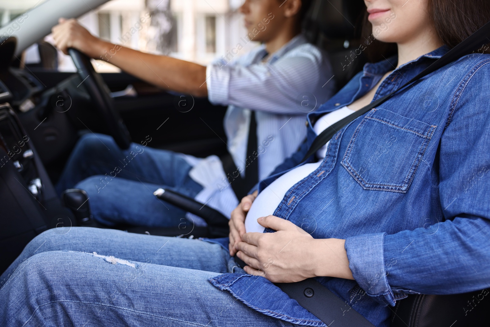 Photo of Pregnant woman travelling with her husband by car, closeup