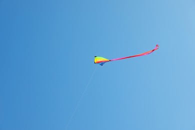Photo of One colorful kite flying in blue sky