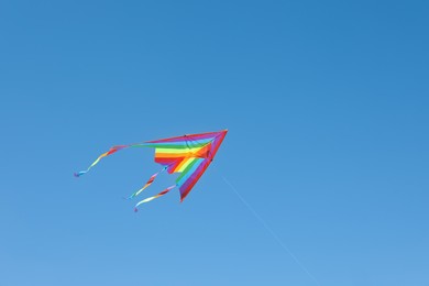 Photo of One colorful kite flying in blue sky